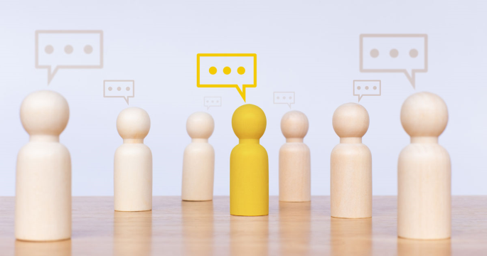 wooden people symbolizing channel partners with talk bubbles 